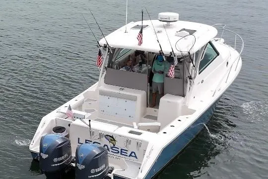 Slide: The Image of 2011 Pursuit OS 345 Offshore boat docked at marina, clear sky, calm water. - 4