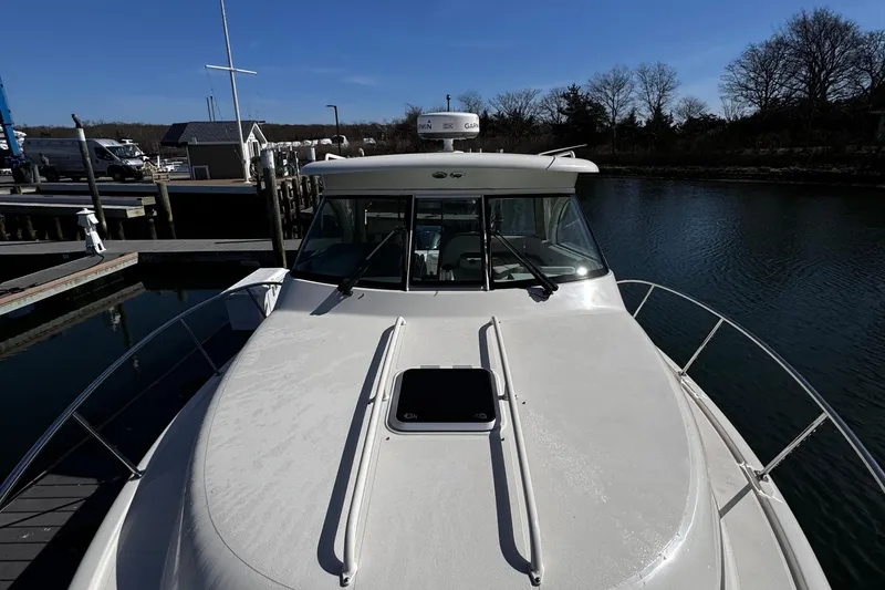 Slide: The Image of 2011 Pursuit OS 345 Offshore boat cruising on open water. - 5