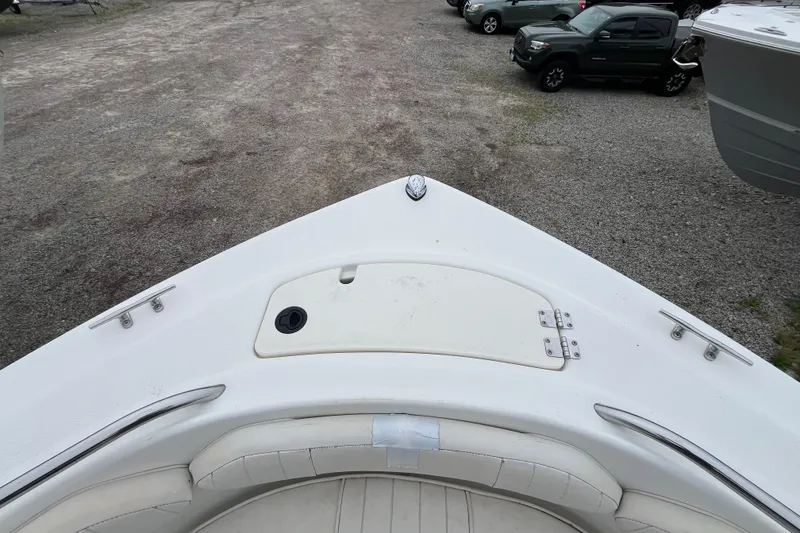 Slide: The Image of 2002 Hydra-Sports 202 DC boat bow view, parked on gravel with cars nearby. - 10