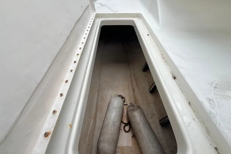 Slide: The Image of Storage compartment of a 2002 Hydra-Sports 212 DC boat with fenders inside. - 14