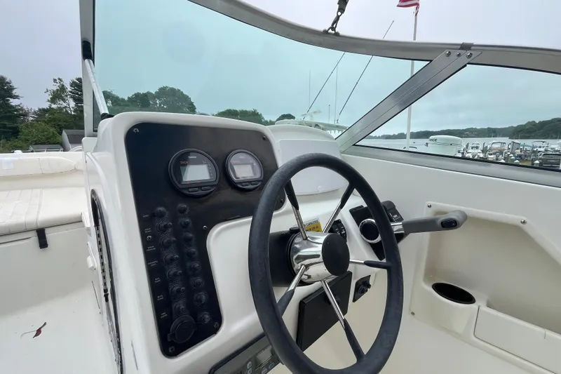 Slide: The Image of 2002 Hydra-Sports 202 DC boat dashboard with steering wheel and instrument panel. - 15