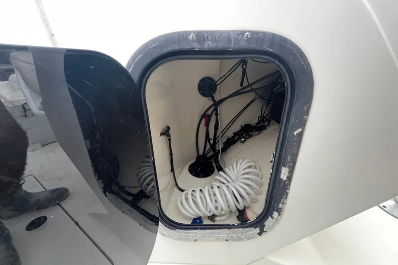 Slide: The Image of Open hatch of 2002 Hydra-Sports 202 DC boat showing coiled cables and wiring. - 17