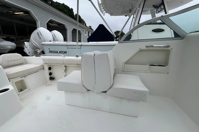 Slide: The Image of 2002 Hydra-Sports 202 DC boat interior with white seating and storage compartments. - 18