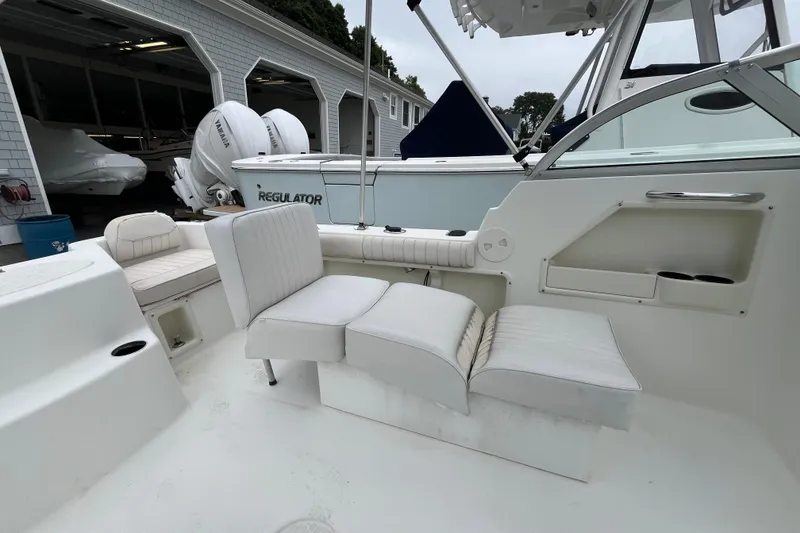 Slide: The Image of 2002 Hydra-Sports 202 DC boat interior with white seating and storage compartments. - 20