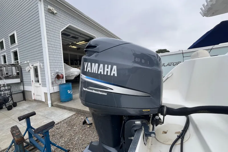 Slide: The Image of 2002 Hydra-Sports 202 DC with Yamaha outboard motor near a boat garage. - 25