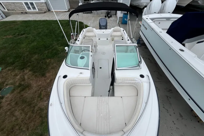 Slide: The Image of 2002 Hydra-Sports 202 DC boat with white seating and dual consoles, docked outdoors. - 28