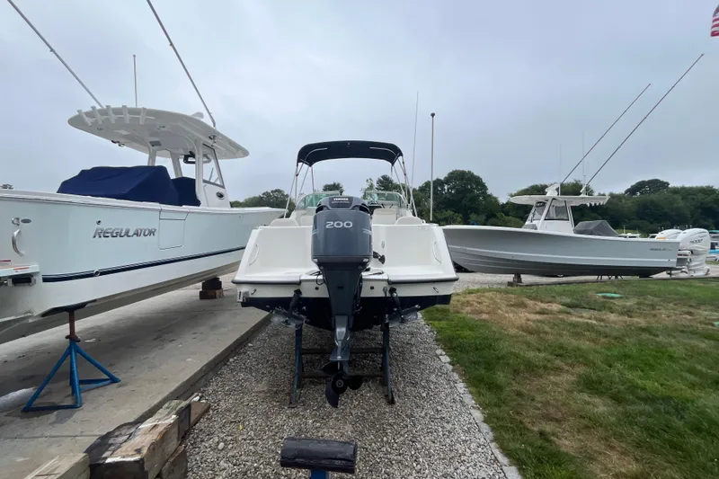 Slide: The Image of 2002 Hydra-Sports 202 DC boat with Yamaha 200 engine, docked alongside other boats. - 3