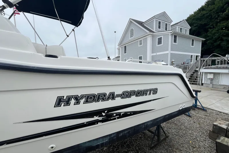 Slide: The Image of 2002 Hydra-Sports 202 DC boat on display near a modern house. - 5