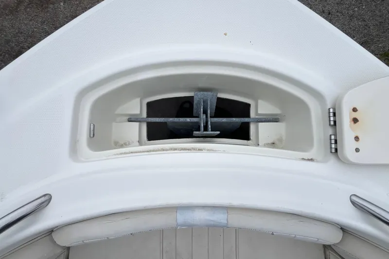 Slide: The Image of 2002 Hydra-Sports 202 DC boat anchor compartment with visible metal anchor and storage area. - 9