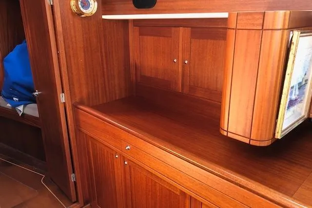 Slide: The Image of Interior of 1999 Sweden Yachts 45, featuring elegant wooden cabinetry and storage. - 14