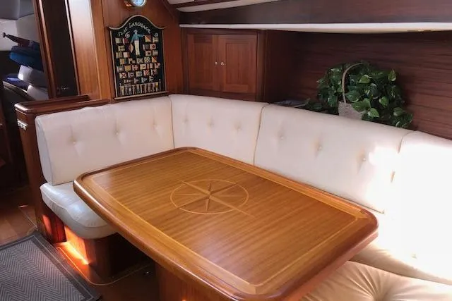 Slide: The Image of Luxurious interior of 1999 Sweden Yachts 45 with elegant wood table and plush seating. - 15