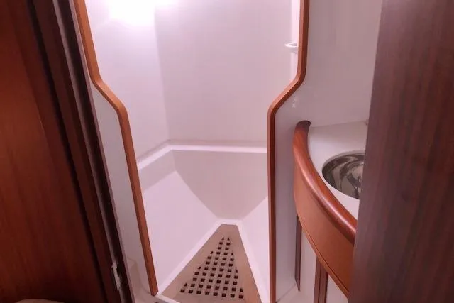 Slide: The Image of Shower area in 1999 Sweden Yachts 45, featuring wooden accents and compact design. - 18
