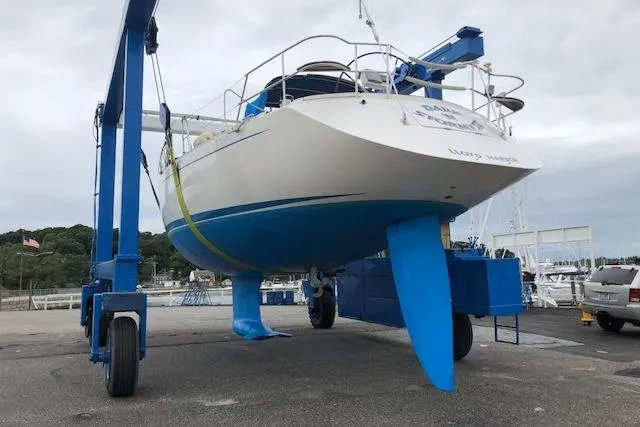 Slide: The Image of 1999 Sweden Yachts 45 sailboat on a lift at a marina. - 23