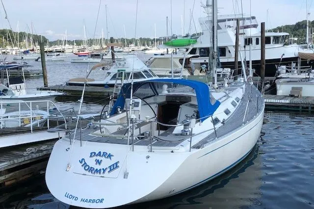 Slide: The Image of 1999 Sweden Yachts 45 sailboat docked at marina, named "Dark N Stormy III". - 30