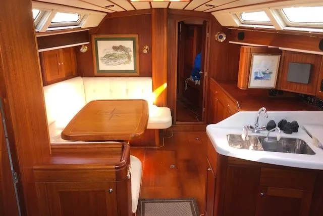 Slide: The Image of Luxurious interior of 1999 Sweden Yachts 45 with wood finish and cozy seating area. - 7