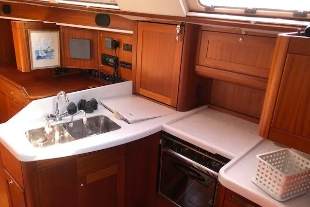 Slide: The Image of Interior of 1999 Sweden Yachts 45, featuring a wooden kitchen with sink and stove. - 8