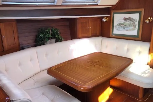 Slide: The Image of Luxurious interior of 1999 Sweden Yachts 45 with elegant wood table and white seating. - 9