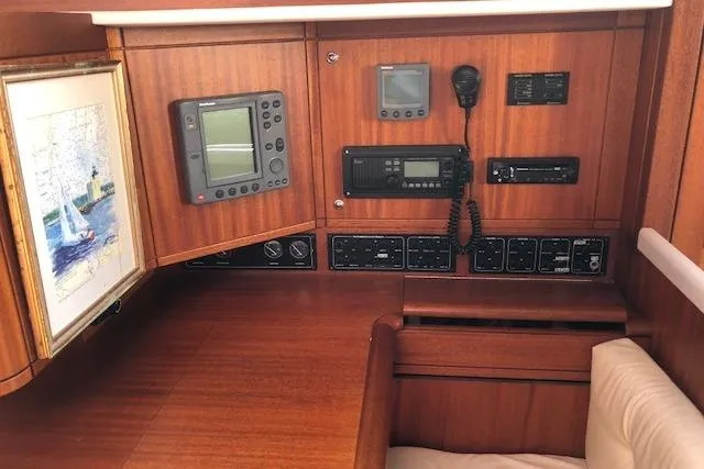 Slide: The Image of Navigation station of 1999 Sweden Yachts 45 with control panels and instruments. - 10