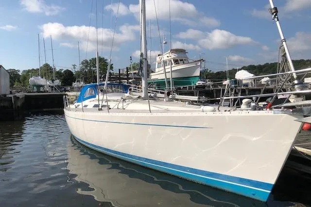 Slide: The Image of Sailing yacht Sweden Yachts 45, 1999 model, docked in a marina under a blue sky. - 2