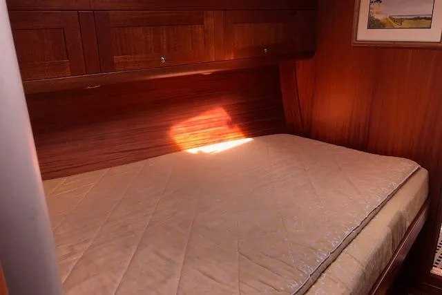 Slide: The Image of Cozy cabin interior of 1999 Sweden Yachts 45 with wooden finish and comfortable bed. - 20