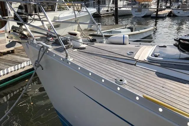 Slide: The Image of Sleek 1999 Sweden Yachts 45 sailboat docked, showcasing elegant deck design and marina setting. - 4