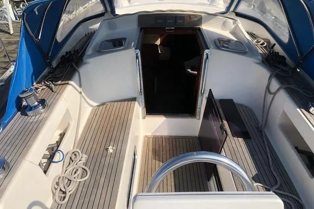 Slide: The Image of Cockpit of 1999 Sweden Yachts 45 sailboat with blue canopy and wooden deck. - 6