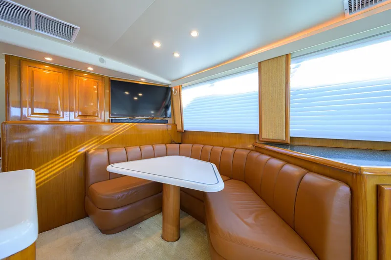 Slide: The Image of Luxurious interior of a 1998 Viking 53 Convertible yacht with leather seating and a flat-screen TV. - 15