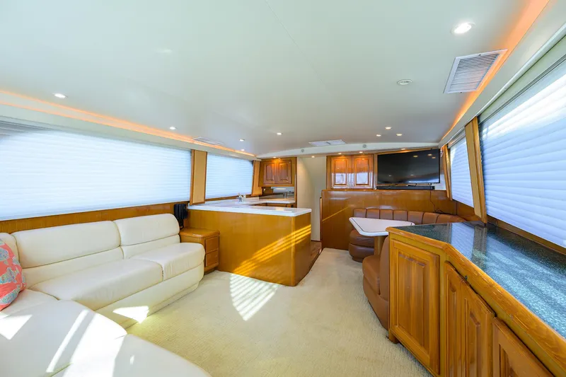 Slide: The Image of Luxurious interior of 1998 Viking 53 Convertible yacht with elegant wood finishes and plush seating. - 17