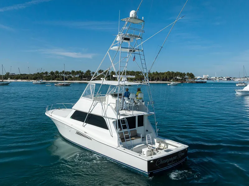 Slide: The Image of 1998 Viking 53 Convertible yacht cruising in clear blue waters. - 2