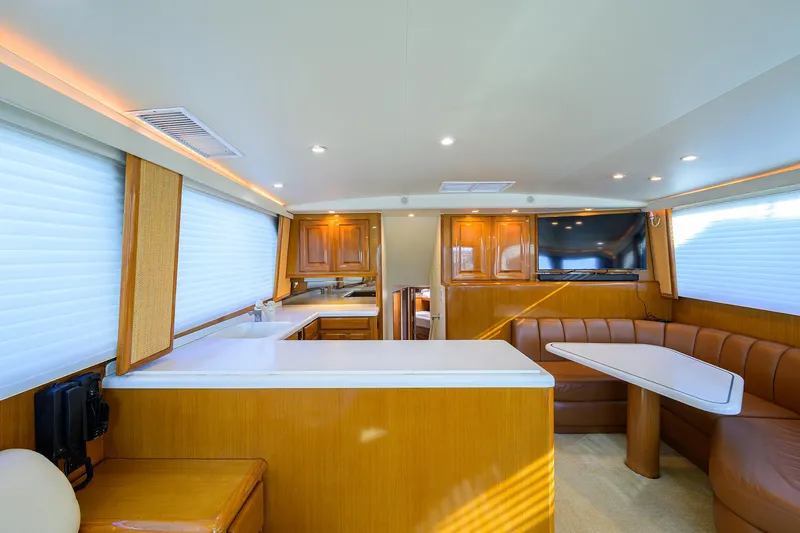 Slide: The Image of Interior of a 1998 Viking 53 Convertible yacht with modern kitchen and dining area. - 22