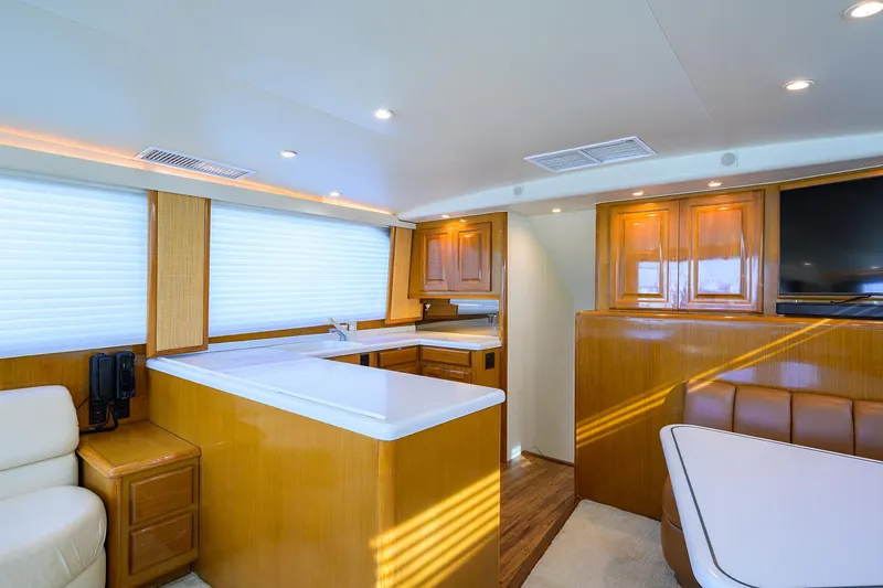 Slide: The Image of Interior of 1998 Viking 53 Convertible yacht with modern wood cabinetry and seating. - 23