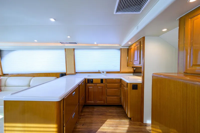 Slide: The Image of Luxurious kitchen interior of a 1998 Viking 53 Convertible yacht with wooden cabinetry. - 24