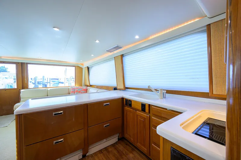 Slide: The Image of Interior of 1998 Viking 53 Convertible yacht with modern kitchen and seating area. - 25