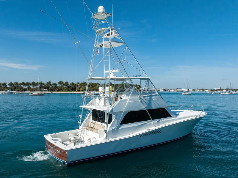 Slide: The Image of 1998 Viking 53 Convertible yacht cruising on clear blue water under a sunny sky. - 3