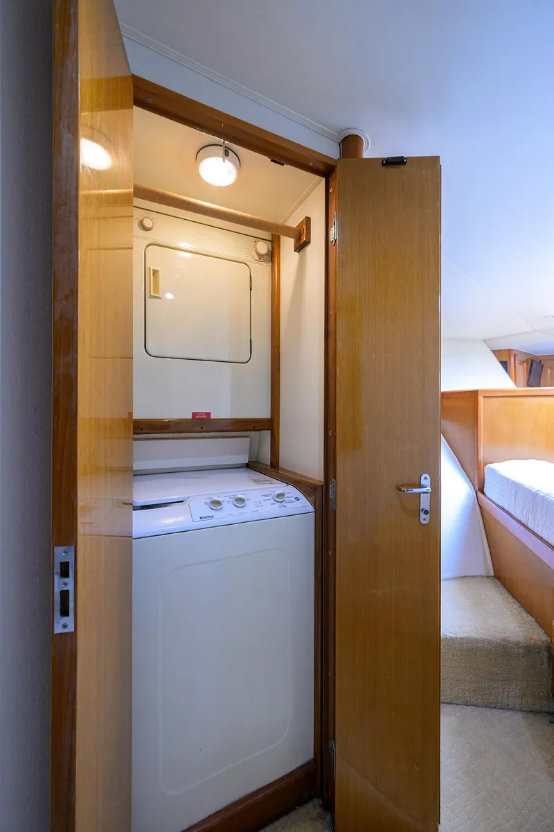 Slide: The Image of Laundry area inside 1998 Viking 53 Convertible yacht with washer and dryer. - 31