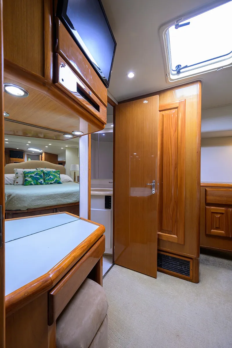 Slide: The Image of Interior of 1998 Viking 53 Convertible yacht with wood finishes and cozy bedroom. - 35