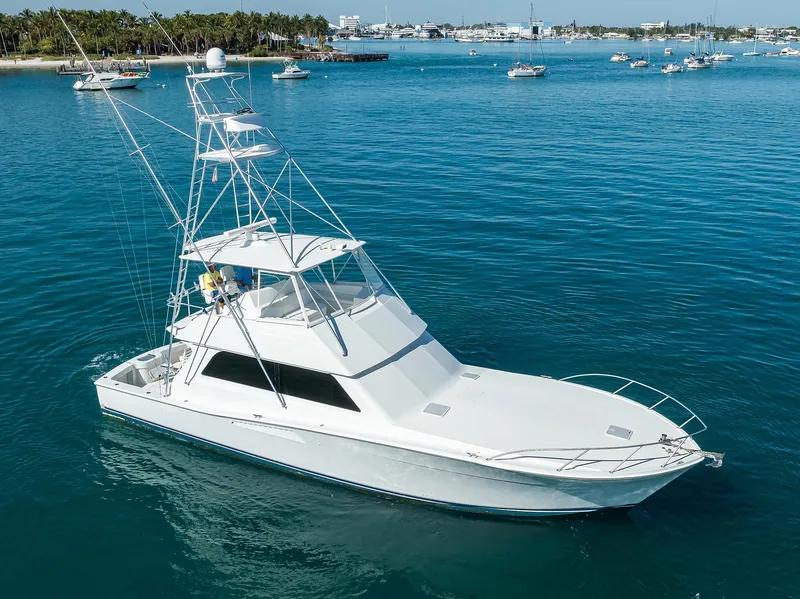 Slide: The Image of 1998 Viking 53 Convertible yacht cruising on clear blue water. - 4