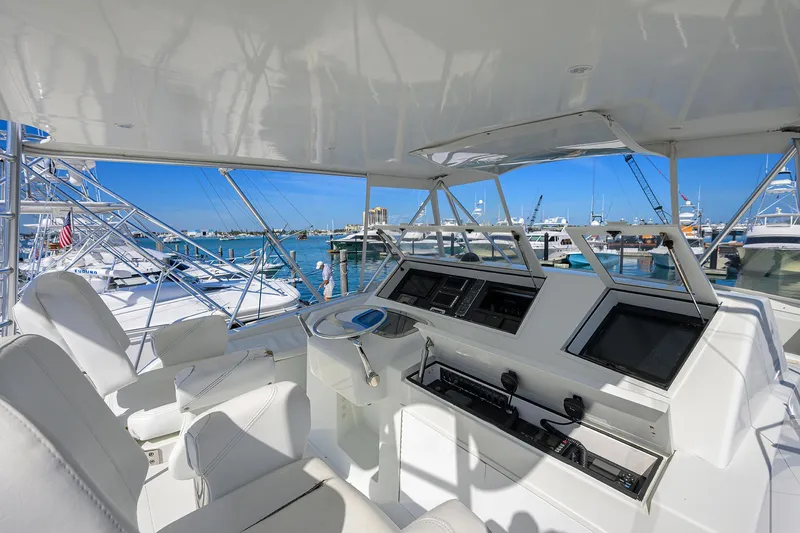 Slide: The Image of Interior view of a 1998 Viking 53 Convertible yacht with modern controls and seating. - 42