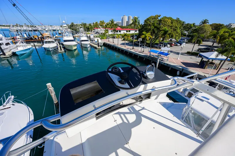 Slide: The Image of 1998 Viking 53 Convertible yacht at marina, view from helm, clear blue sky. - 49
