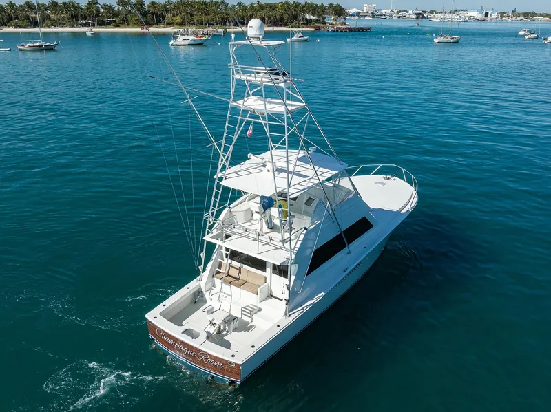 Slide: The Image of 1998 Viking 53 Convertible yacht cruising in clear blue waters. - 6