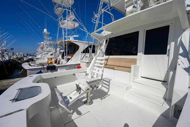 Slide: The Image of 1998 Viking 53 Convertible yacht with spacious deck and fishing chair, docked at marina. - 9