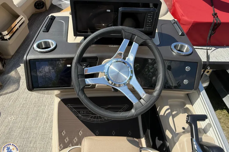 Slide: The Image of Steering console of 2025 Bennington 22ML boat with modern controls and cup holders. - 10