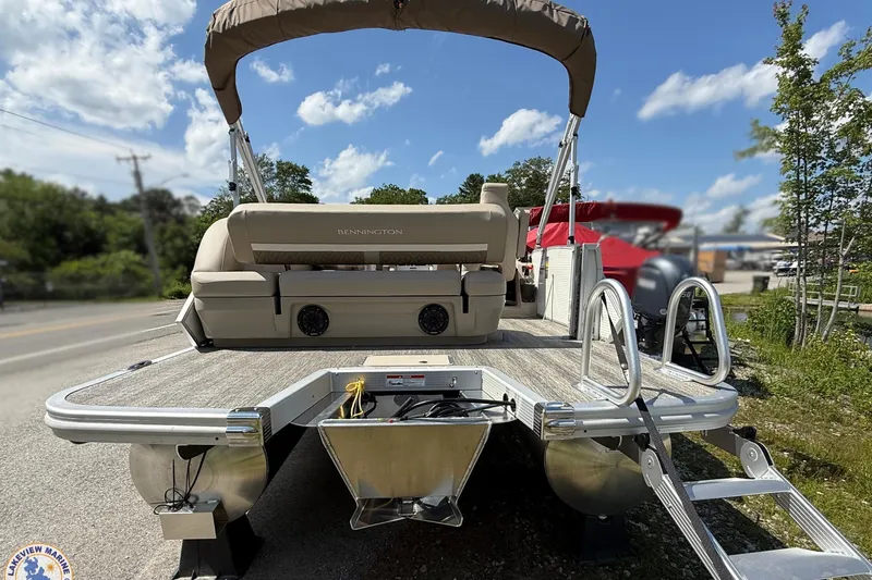 Slide: The Image of 2025 Bennington 22ML pontoon boat with canopy, rear view on a sunny day. - 3