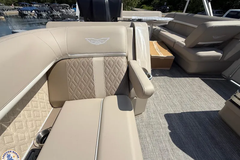 Slide: The Image of Luxurious interior of 2025 Bennington 22ML pontoon boat with beige seating and cup holders. - 7