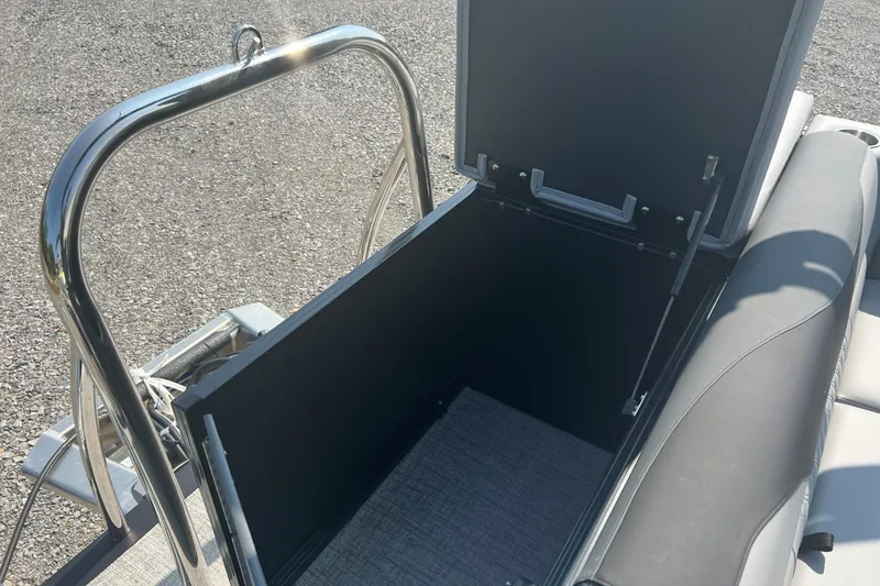 Slide: The Image of Open storage compartment on 2026 Tahoe Pontoon 1980 CRUISE boat, featuring sleek design. - 14