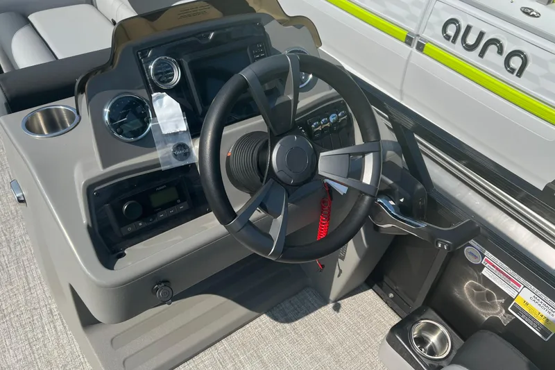 Slide: The Image of Steering console of 2026 Tahoe Pontoon 1980 CRUISE with modern controls and cup holders. - 17