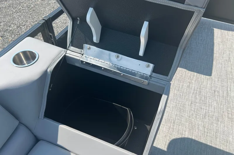 Slide: The Image of Tahoe Pontoon 1980 CRUISE 2026 model with open storage compartment and cup holder. - 20