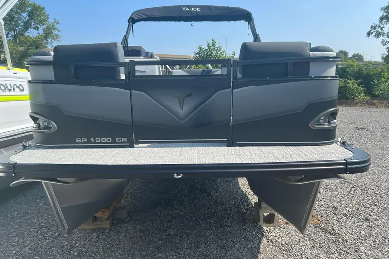 Slide: The Image of 2026 Tahoe Pontoon 1980 CRUISE boat, rear view, parked on gravel. - 3