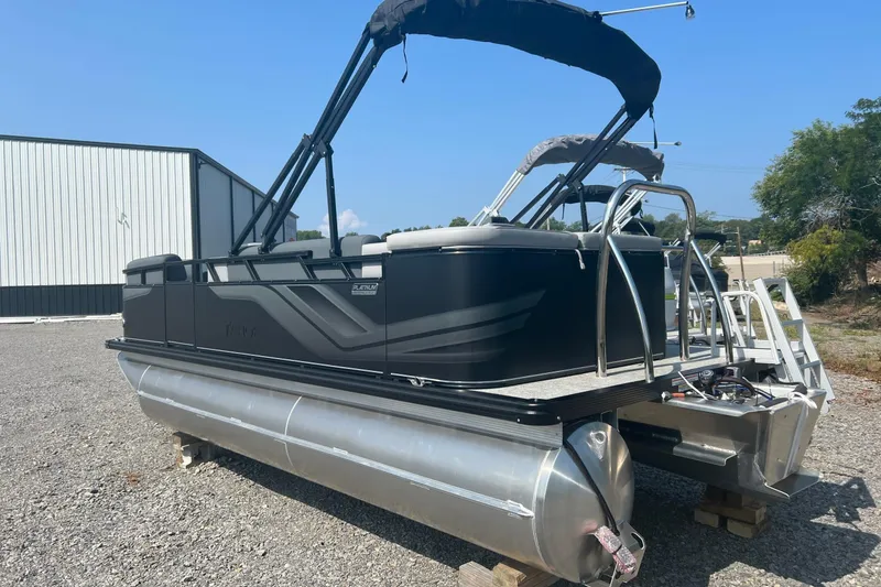 Slide: The Image of 2026 Tahoe Pontoon 1980 CRUISE boat with canopy, parked outdoors on gravel. - 5
