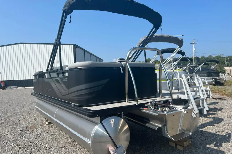 Slide: The Image of 2026 Tahoe Pontoon 1980 CRUISE boat with canopy, displayed outdoors on gravel. - 6